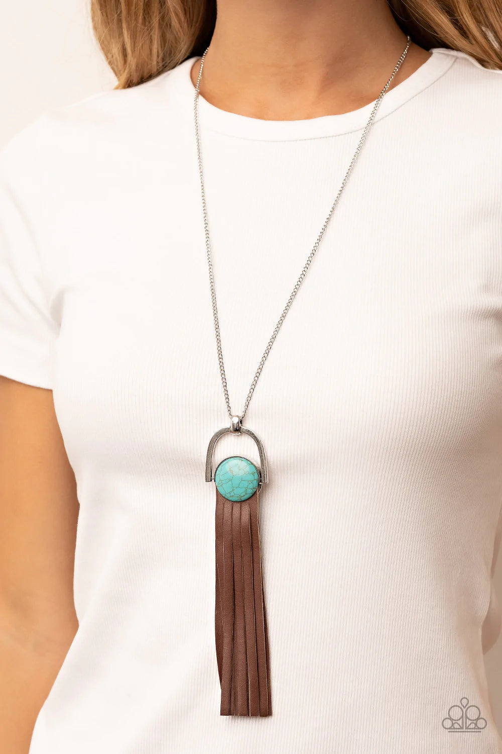 Paparazzi Accessories Winslow Wanderer - Blue Strips of brown leather fan out from the bottom of a round turquoise stone that is threaded along a metal rod that attaches to the bottom of a silver horseshoe frame. The earthy pendant swings from the bottom