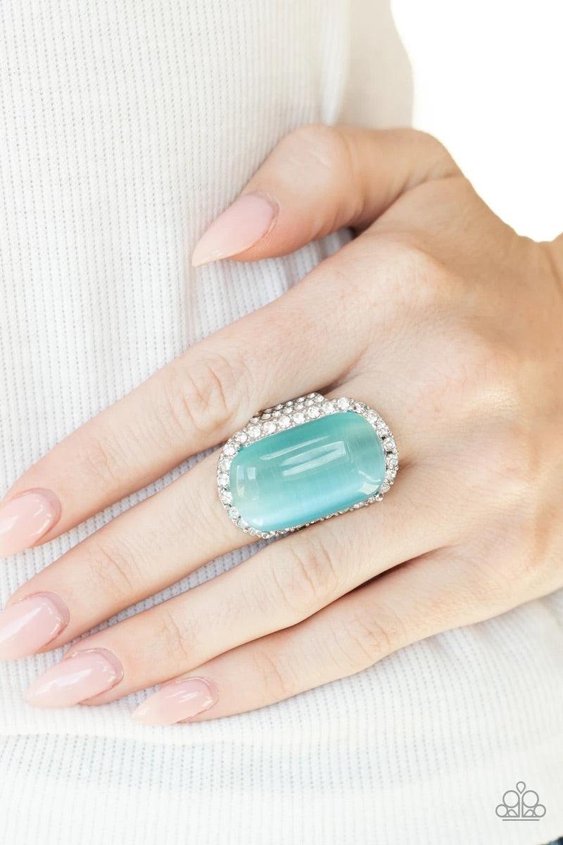 Paparazzi Accessories Thank Your LUXE-y Stars - Blue An oversized blue cat's eye stone sits atop an icy silver frame bedazzled in blinding white rhinestones for a luxurious look. Features a stretchy band for a flexible fit. Sold as one individual ring. Ri