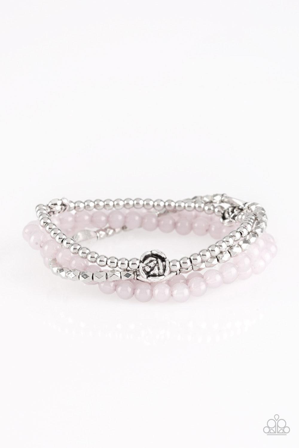 Paparazzi Accessories Blooming Buttercups - Silver Mismatched silver beads and strands of glassy gray beads are threaded along stretchy bands. Infused with silver accents, dainty rose blossoms adorn the wrist for a seasonal finish. Jewelry