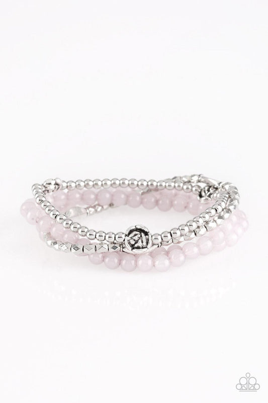 Paparazzi Accessories Blooming Buttercups - Silver Mismatched silver beads and strands of glassy gray beads are threaded along stretchy bands. Infused with silver accents, dainty rose blossoms adorn the wrist for a seasonal finish. Jewelry