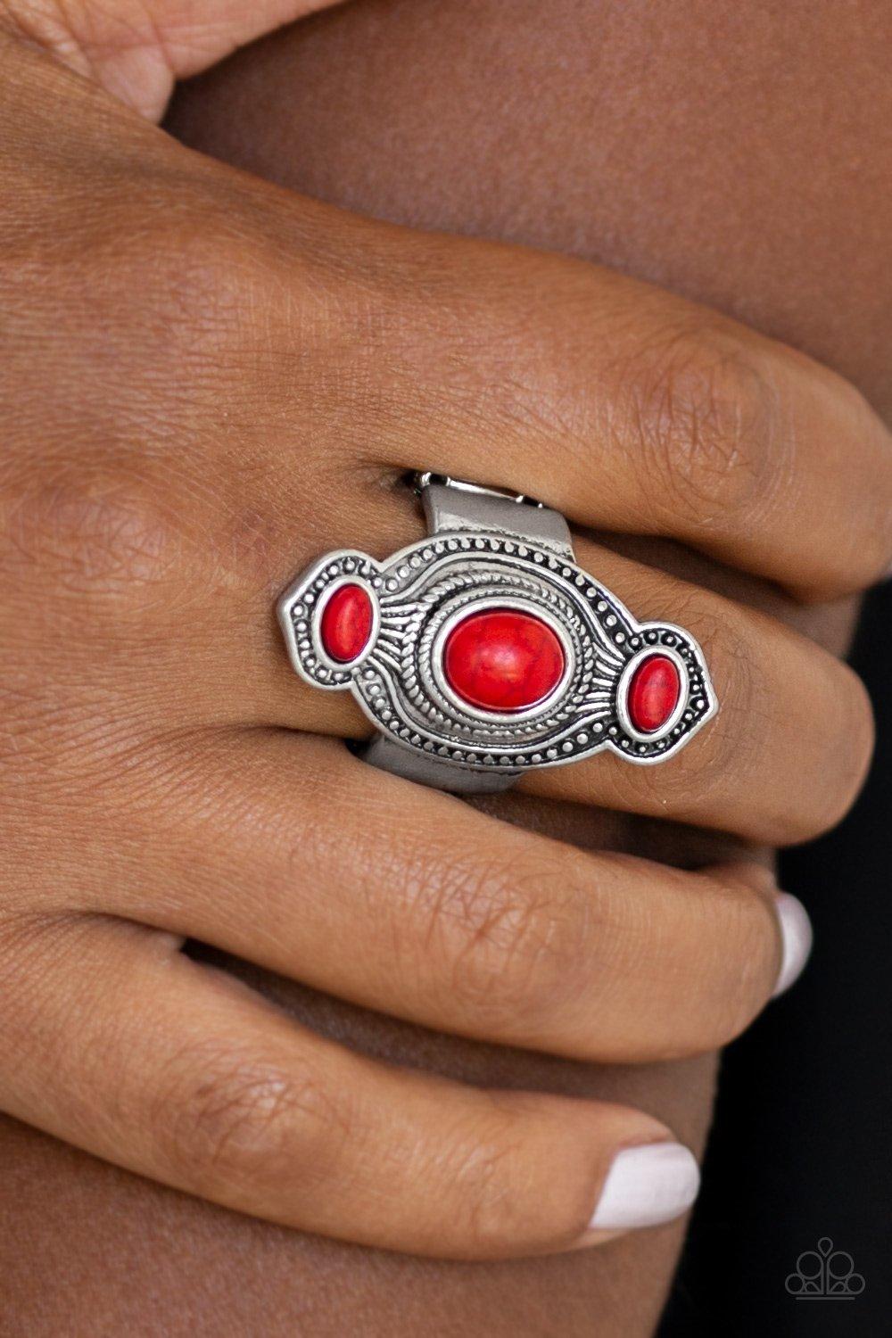 Paparazzi Accessories Dune Drifter - Red Three fiery red stones are pressed into an abstract silver frame radiating with texture and studded details for a seasonal look. Features a stretchy band for a flexible fit. Jewelry