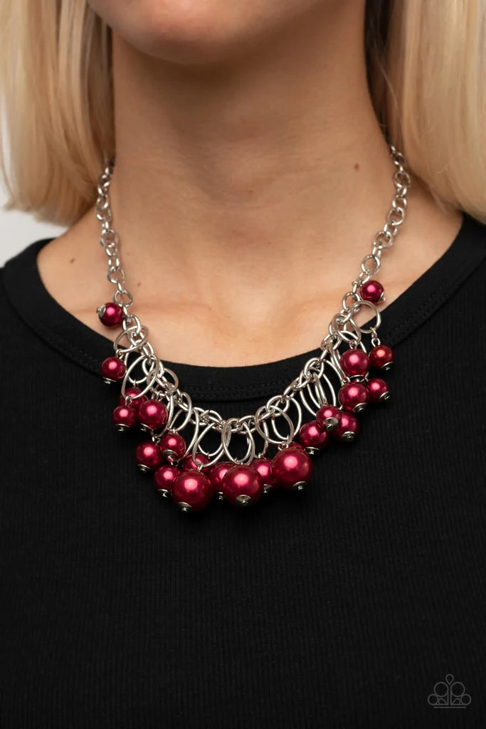 Paparazzi Accessories Powerhouse Pose - Red Oversized red pearls dance from the bottoms of shiny silver ovals that delicately cluster along a chunky silver chain, resulting in a luxurious fringe below the collar. Features an adjustable clasp closure. Sold
