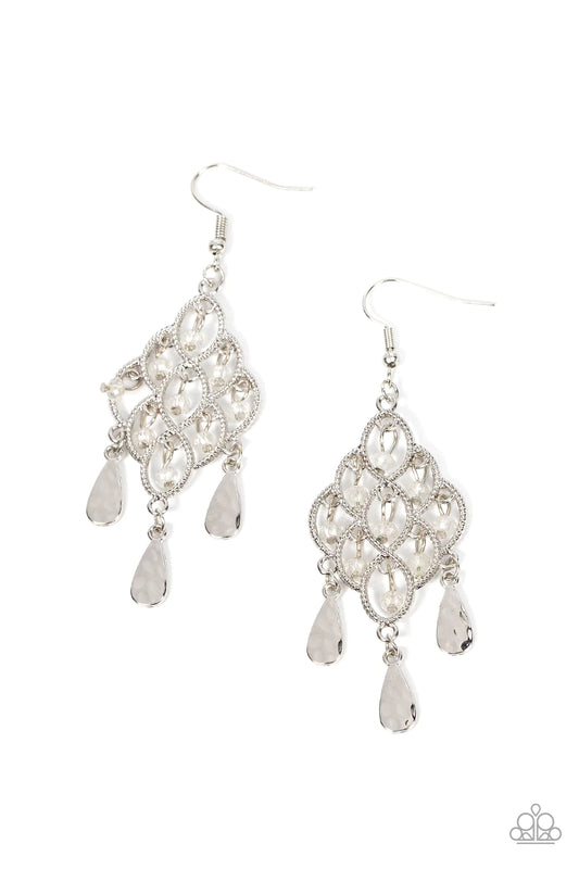 Paparazzi Accessories Sentimental Shimmer - White Hammered silver teardrops swing from the bottom of a frame composed of silvery ropelike filigree that gently loops into an airy diamond shape. Tiers of dainty white crystal-like beads cascade from the fril