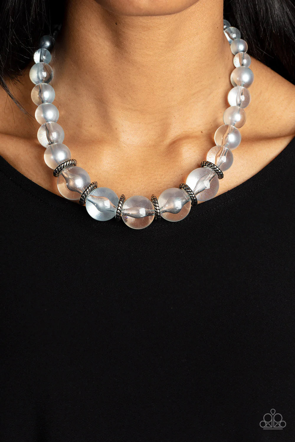 Paparazzi Accessories Marina Mirage - Blue Lightly brushed in a pearly Spun Sugar shimmer, glassy translucent beads gradually increase in size as they are threaded along an invisible wire below the collar. Textured silver rings separate the largest beads,
