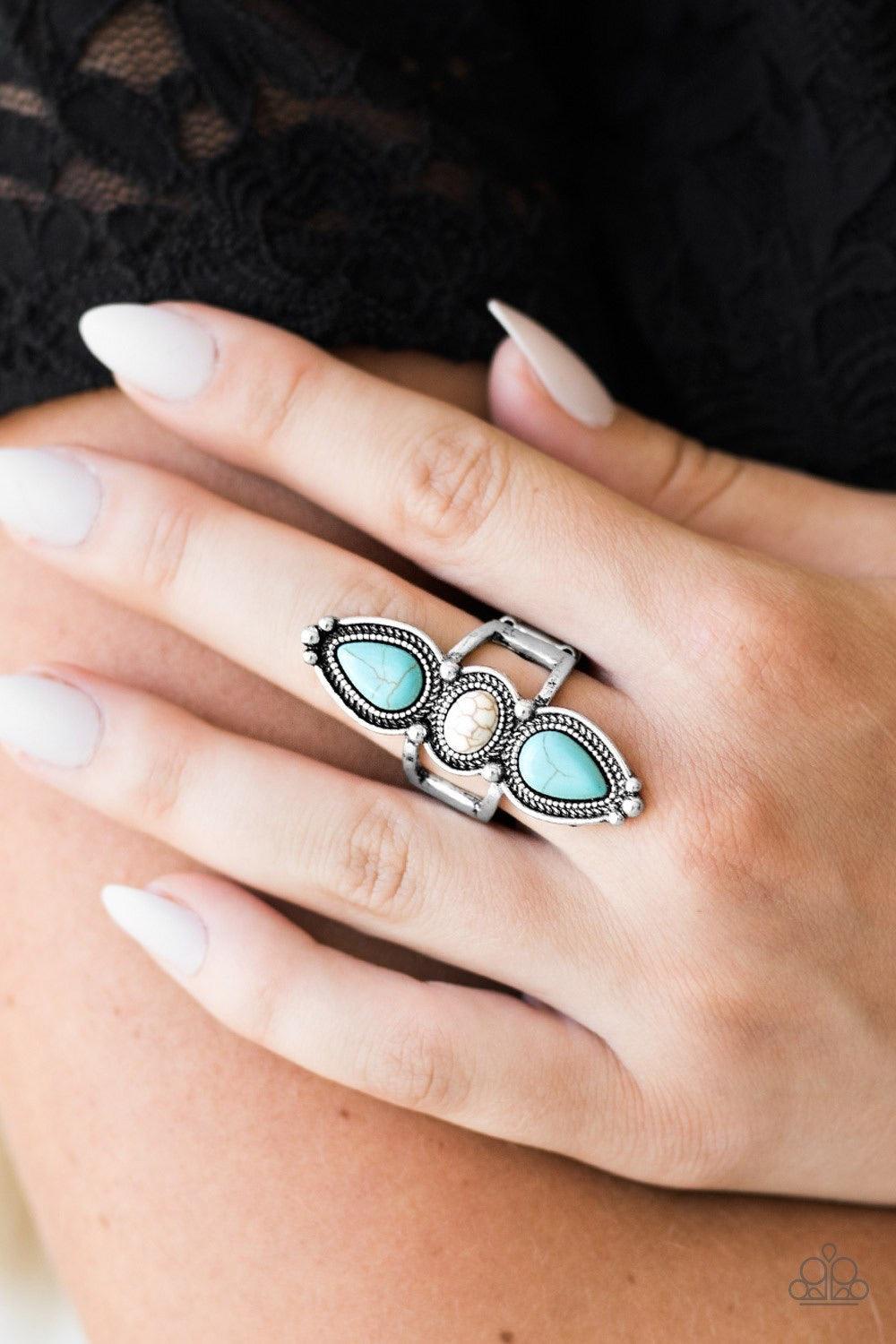 Paparazzi Accessories Calling All Chiefs - Multi Smooth turquoise and white stone beads are pressed into an elongated silver frame. Dotted with silver studs and embossed in stunning rope-like textures, the dramatic frame extends down the finger in a simpl