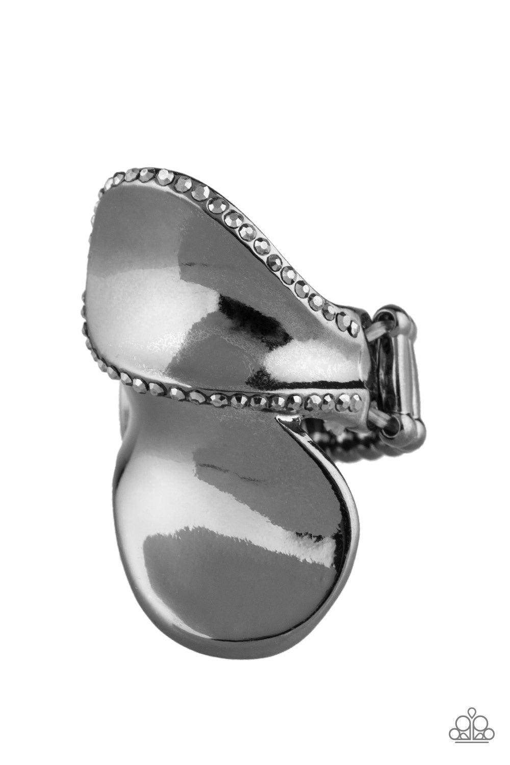 Paparazzi Accessories Fabulously Folded - Black Bordered in sections of glittery hematite rhinestones, glistening gunmetal frames fold across the finger for an edgy look. Features a stretchy band for a flexible fit. Jewelry