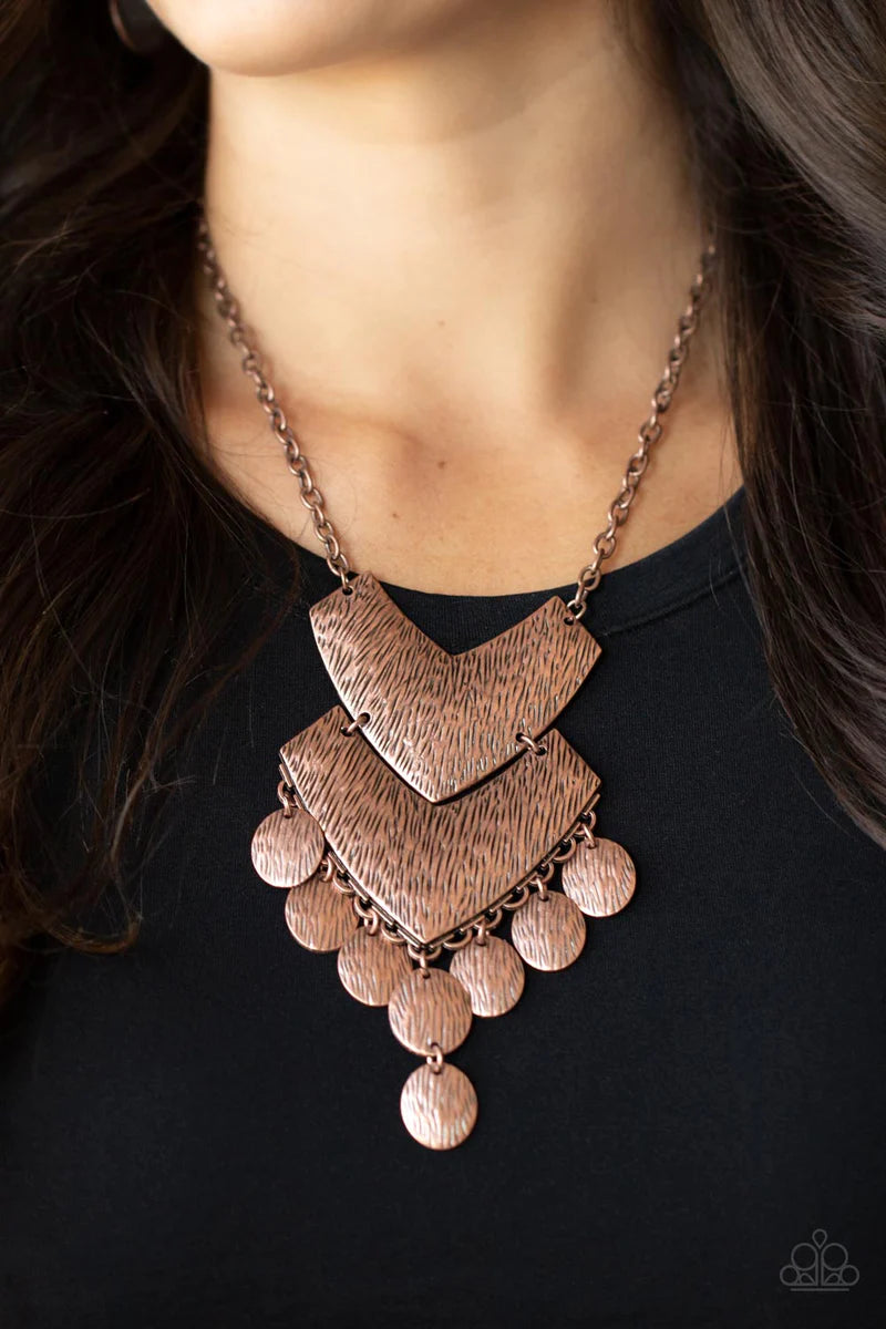 Paparazzi Accessories Keys to the ANIMAL Kingdom - Copper Etched in rustic copper textures, a pair oversized chevron-like copper frames delicately link into a wild statement piece. Matching textured copper discs swing from the bottom of the stacked displa
