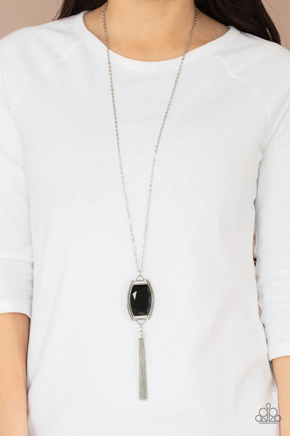 Paparazzi Accessories Timeless Talisman - Black Encased in an antiqued silver frame, an oversized black gem swings from the bottom of an ornate silver chain. A shimmery silver chain tassel swings from the bottom of the sparkly pendant, creating a regal ta