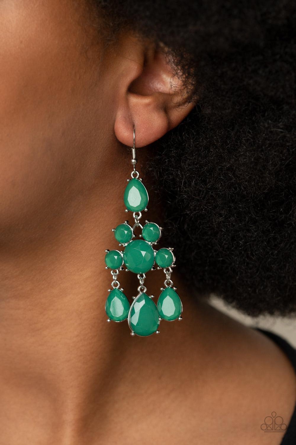 Paparazzi Accessories Afterglow Glamour - Green A dewy collection of glassy round and teardrop green gems delicately connect into an elegant chandelier. Earring attaches to a standard fishhook fitting. Sold as one pair of earrings. Jewelry