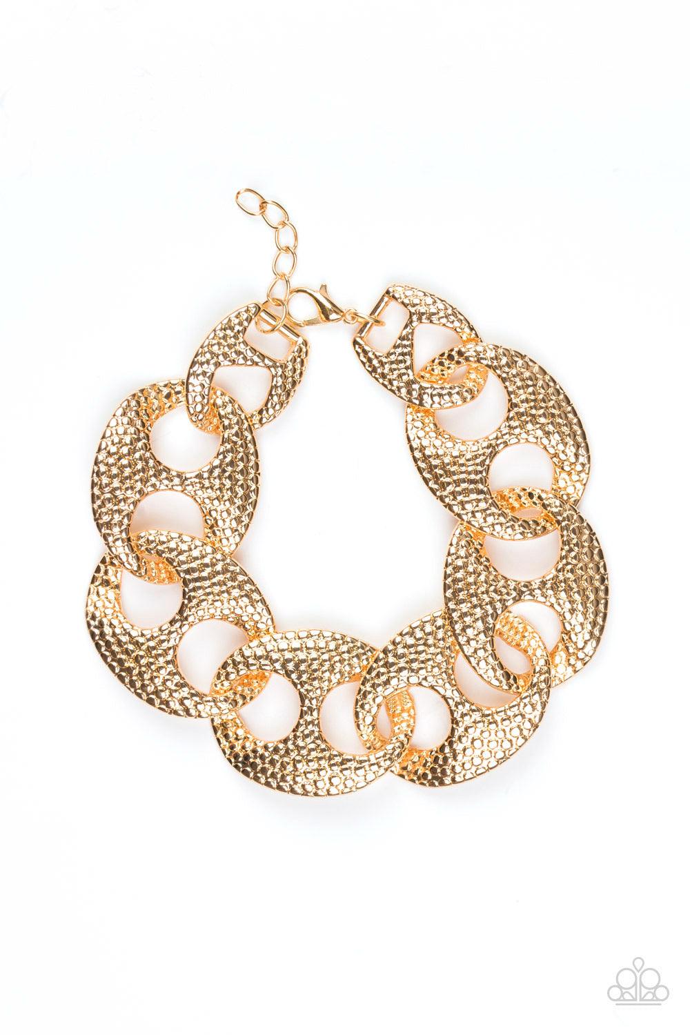 Paparazzi Accessories Casual Connossieur - Gold Embossed in shimmery circular patterns, asymmetrical gold frames link across the wrist for a casually industrial look. Features an adjustable clasp closure. Jewelry