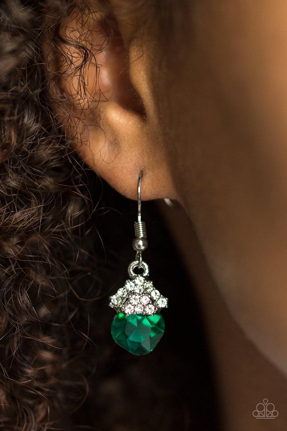 Paparazzi Accessories The Show Must GLOW On! - Green Encrusted in glittery white rhinestones, shimmery silver frames stack atop a faceted green gem for a dramatic look. Earring attaches to a standard fishhook fitting. Jewelry