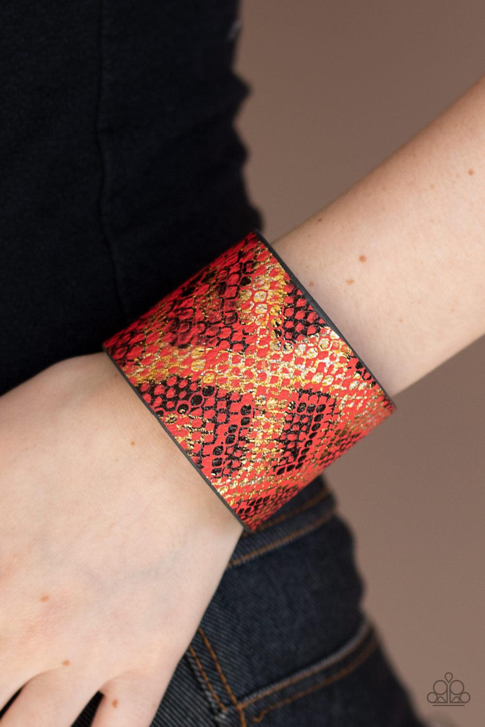Paparazzi Accessories Serpent Shimmer - Red Featuring a shiny gold and black python print, a thick red leather band wraps around the wrist for a wild shimmer. Features an adjustable snap clos Jewelry