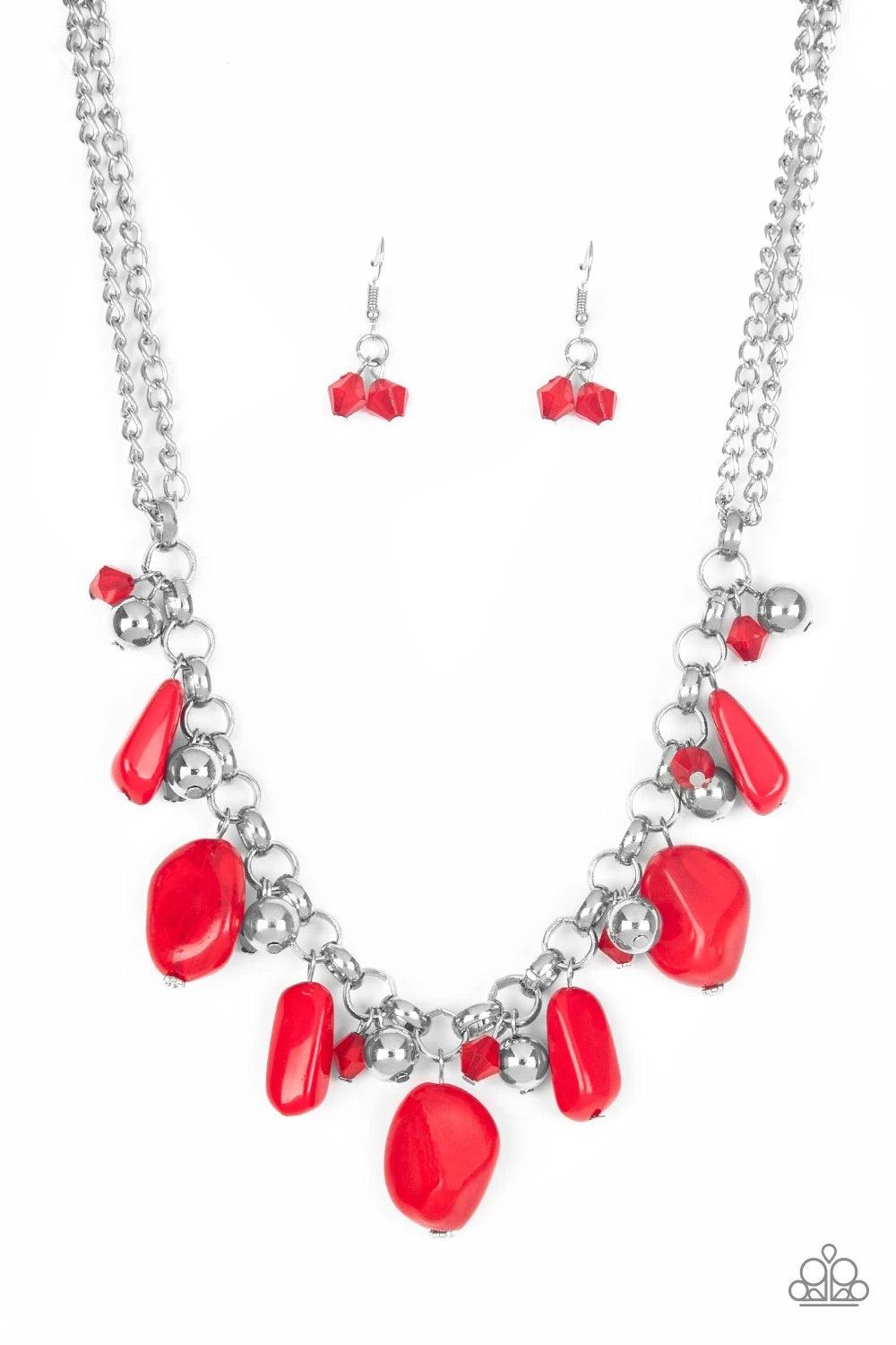 Paparazzi Accessories Grand Canyon Grotto - Red Featuring polished and cloudy finishes, a collection of red faux rocks dance from the bottom of a bold silver chain. Classic silver beads trickle between the colorful beading, adding a metallic shimmer to th