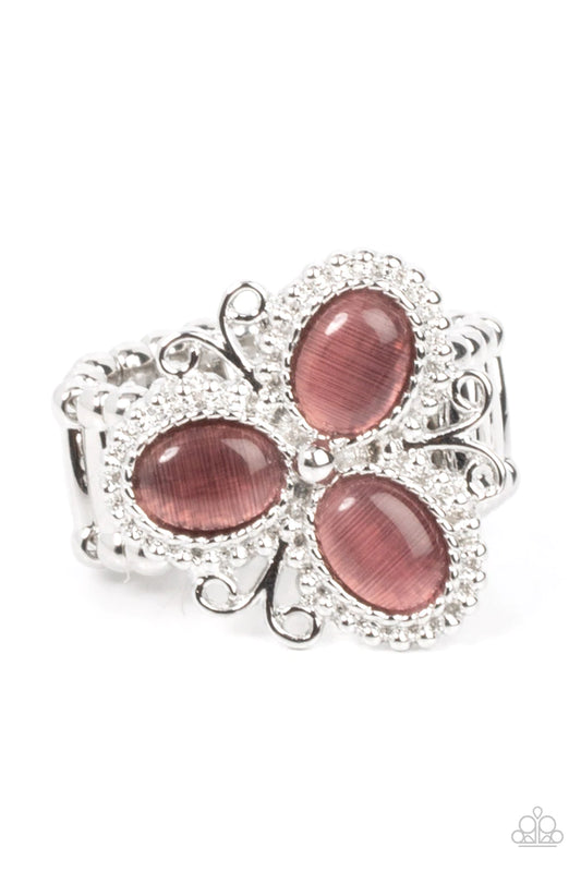 Paparazzi Accessories Bewitched Blossoms - Purple Three oval purple cat's eye stones are encased in studded silver fittings featuring filigree accents, blooming into a magical floral centerpiece atop the finger. Features a stretchy band for a flexible fit