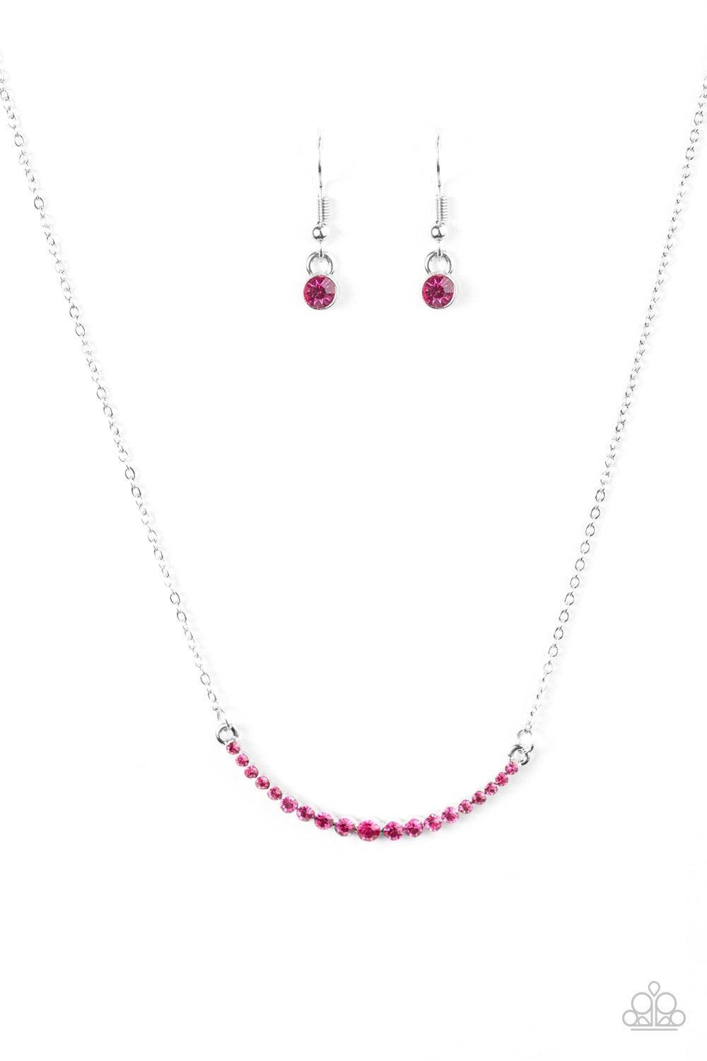 Paparazzi Accessories Rockin Rhinestones - Pink Glittery pink rhinestones join into a bowing pendant, creating a timeless frame below the collar. The sparkling rhinestones gradually increase in size as they near the center of the pendant for a classic fin