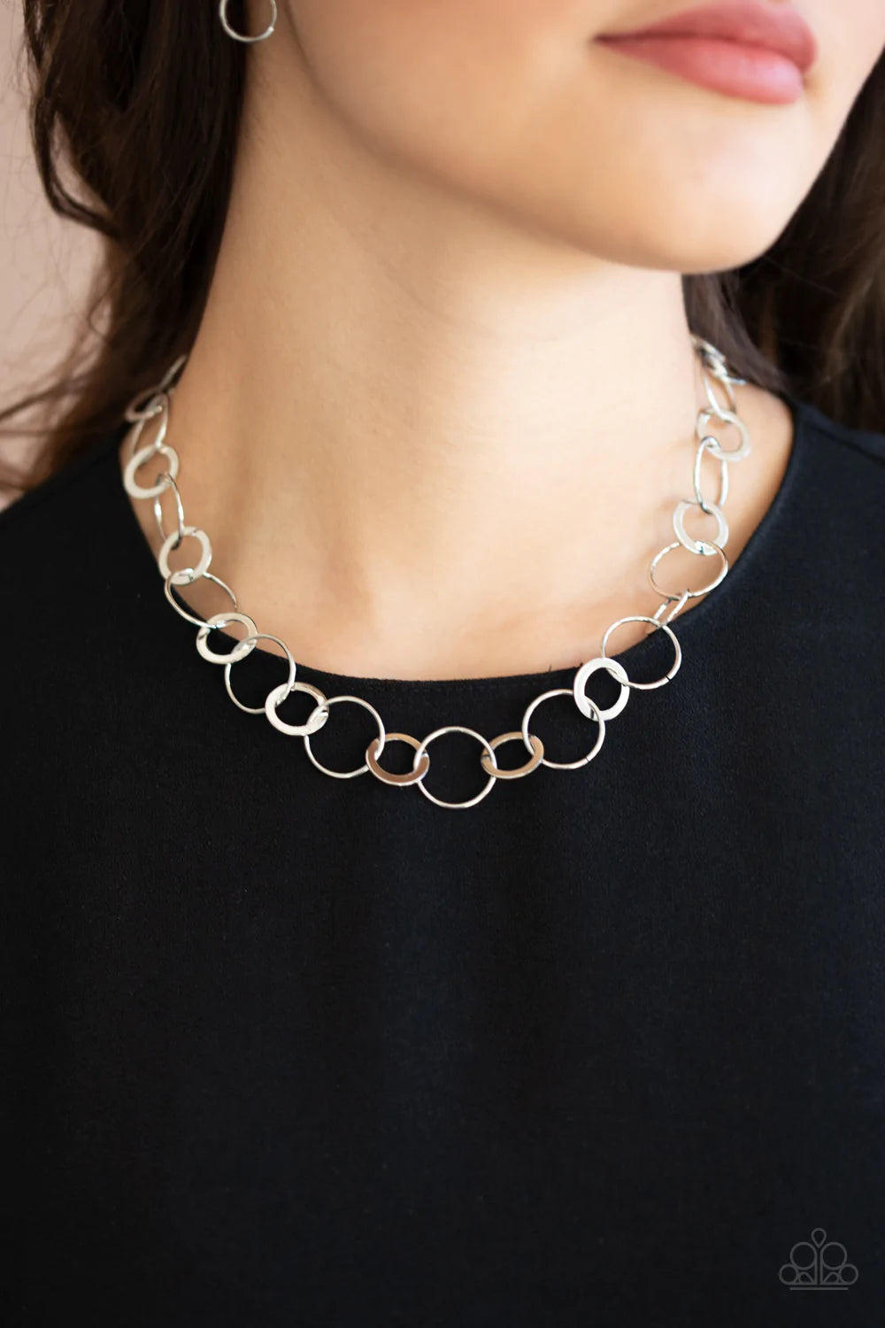 Paparazzi Accessories Revolutionary Radiance - Silver Dainty silver hoops and rings delicately link into a chic chain, creating simplistic shimmer below the collar. Features an adjustable clasp closure. Sold as one individual necklace. Includes one pair o