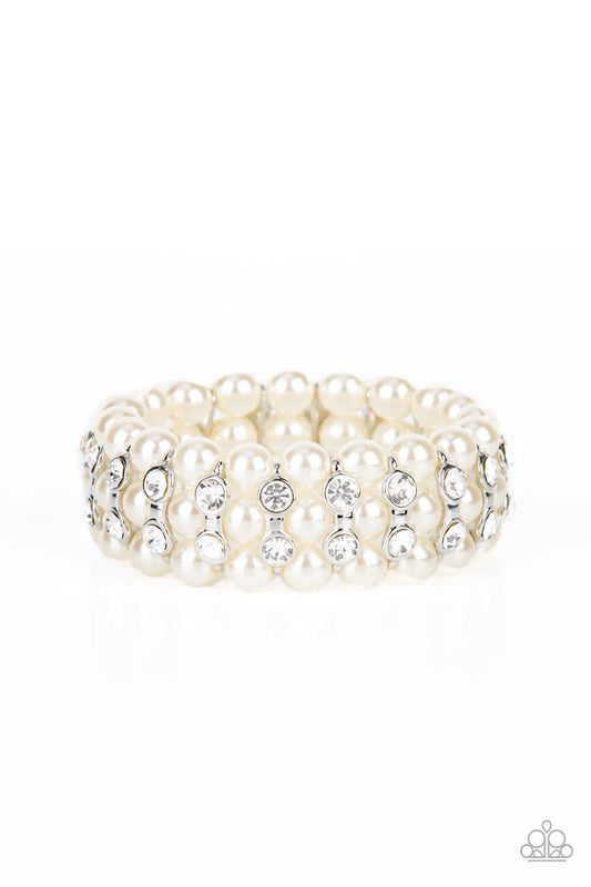 Paparazzi Accessories Eiffel Tower Elegance - White Stacked rows of bubbly white pearls alternate with white rhinestone encrusted silver frames along stretchy bands, adding a timeless twist to the traditional pearl palette. Sold as one individual bracelet