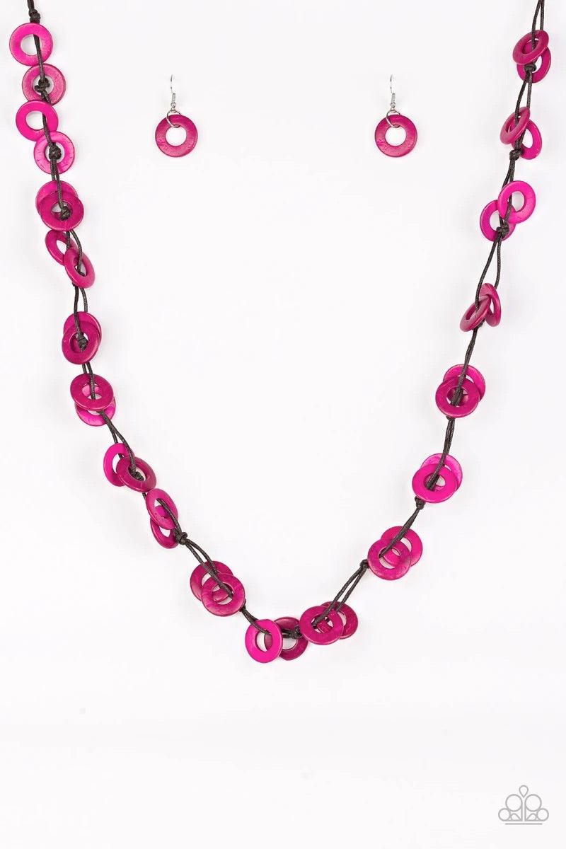 Paparazzi Accessories Waikiki Winds - Pink Shiny brown cording knots around vivacious pink wooden discs, creating a colorful display across the chest. Features a button loop closure. Sold as one individual necklace. Includes one pair of matching earrings.