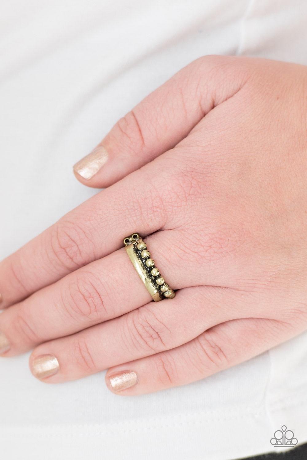 Paparazzi Accessories Glow by Glow - Brass A glistening brass band is dotted in shiny brass studs for an edgy look. Features a stretchy band for a flexible fit. Jewelry