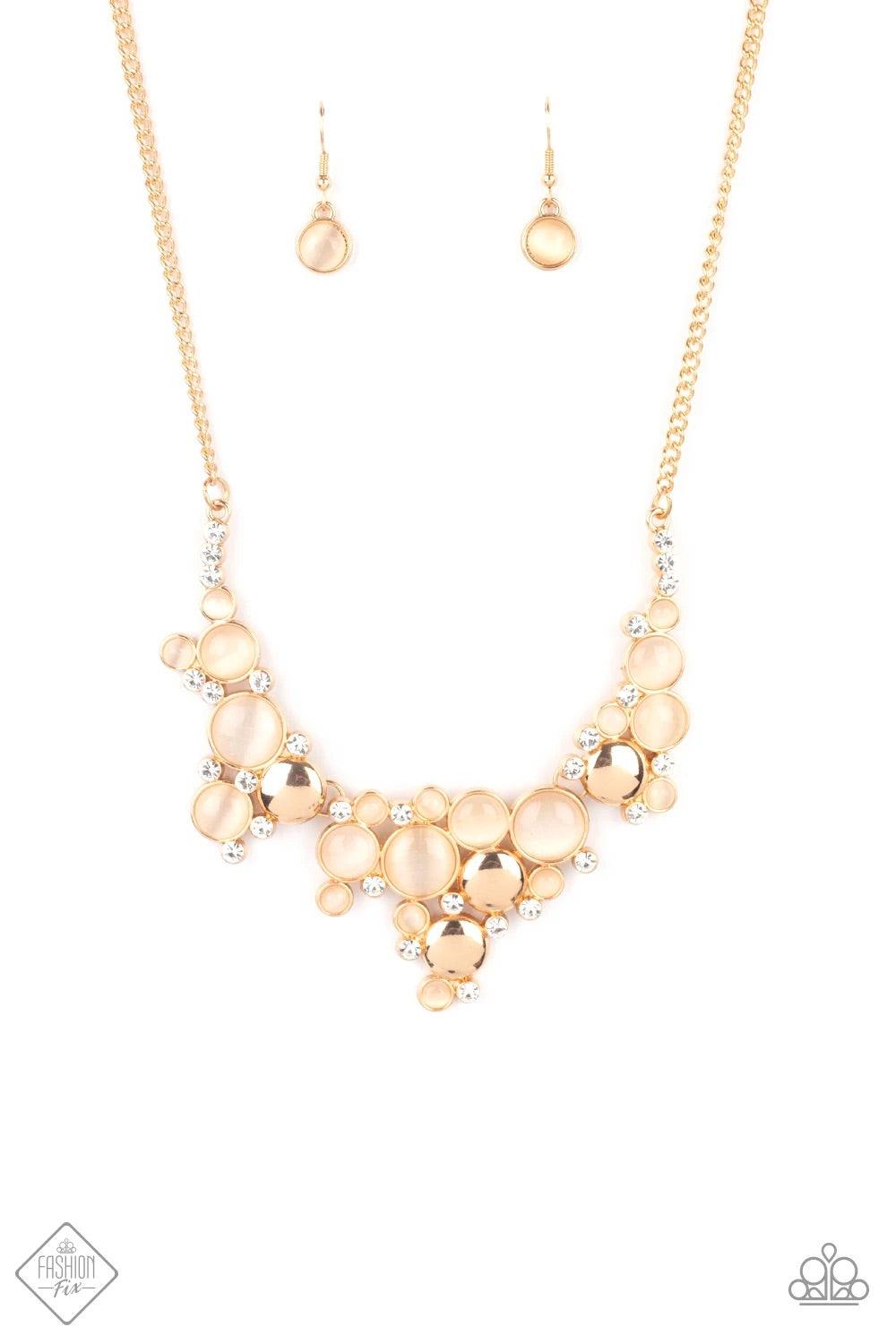 Paparazzi Accessories Fairytale Affair - Gold A bubbly collection of champagne cat's eye stones, glassy white rhinestones, and glistening gold discs delicately coalesces into enchanting frames below the collar that link into a whimsical centerpiece. Featu
