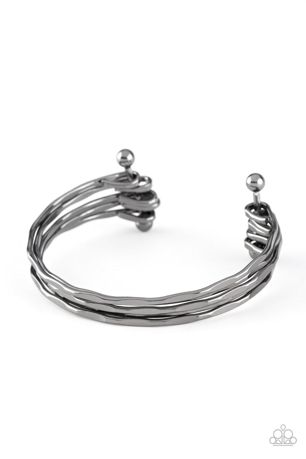 Paparazzi Accessories Street Refinement - Black Delicately hammered in sections of shimmer, glistening gunmetal bars are threaded along two metallic rods, creating a layered cuff across the wrist. Sold as one individual bracelet. Jewelry