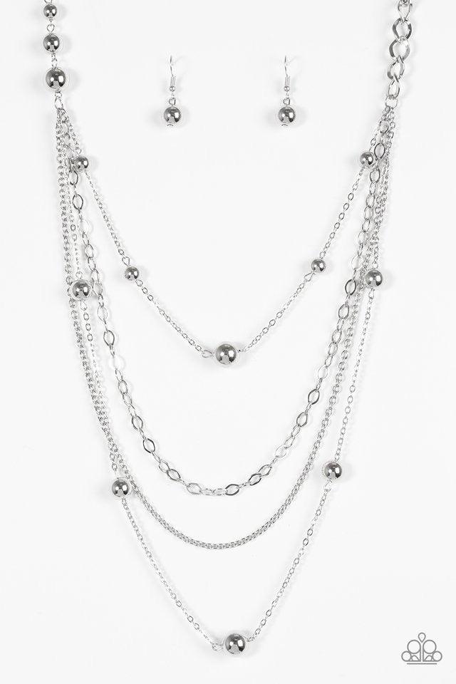 Paparazzi Accessories Boss Shimmer - Silver A mishmash of classic silver beading and bold chain links trickle along shimmery silver chains, creating an asymmetrically layered look. Features an adjustable clasp closure. Sold as one individual necklace. Inc