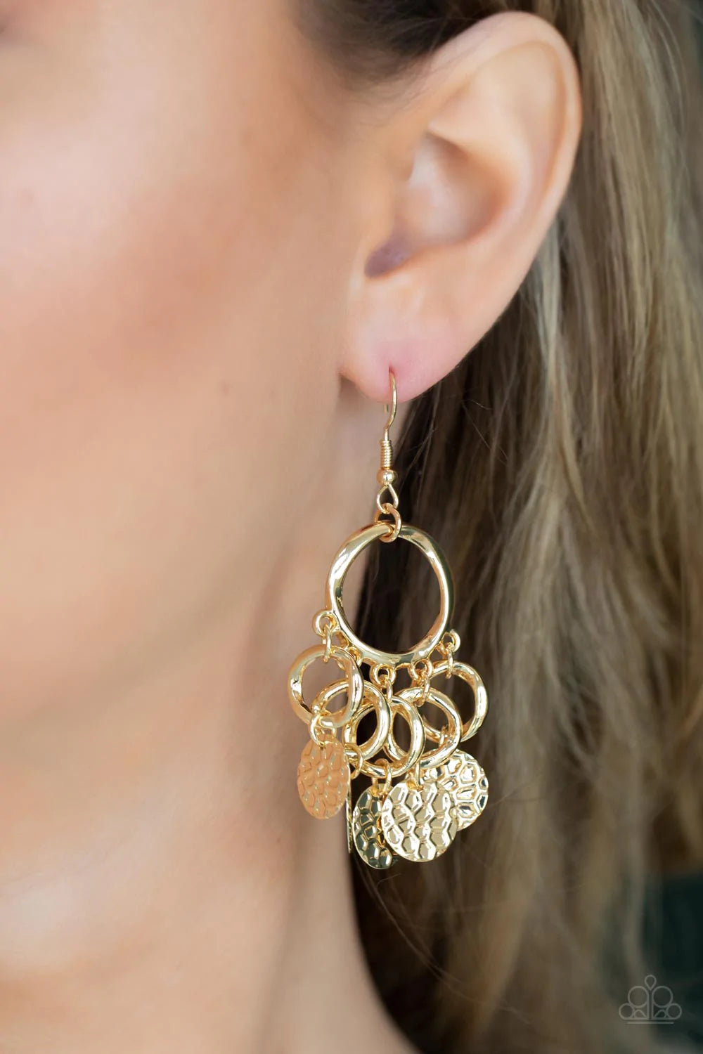 Paparazzi Accessories Partners in Chime - Gold Embossed in tactile geometric patterns, shiny gold discs swing from the bottom of dainty gold rings at the bottom of an asymmetrical gold ring for a noise-making fashion. Earring attaches to a standard fishho