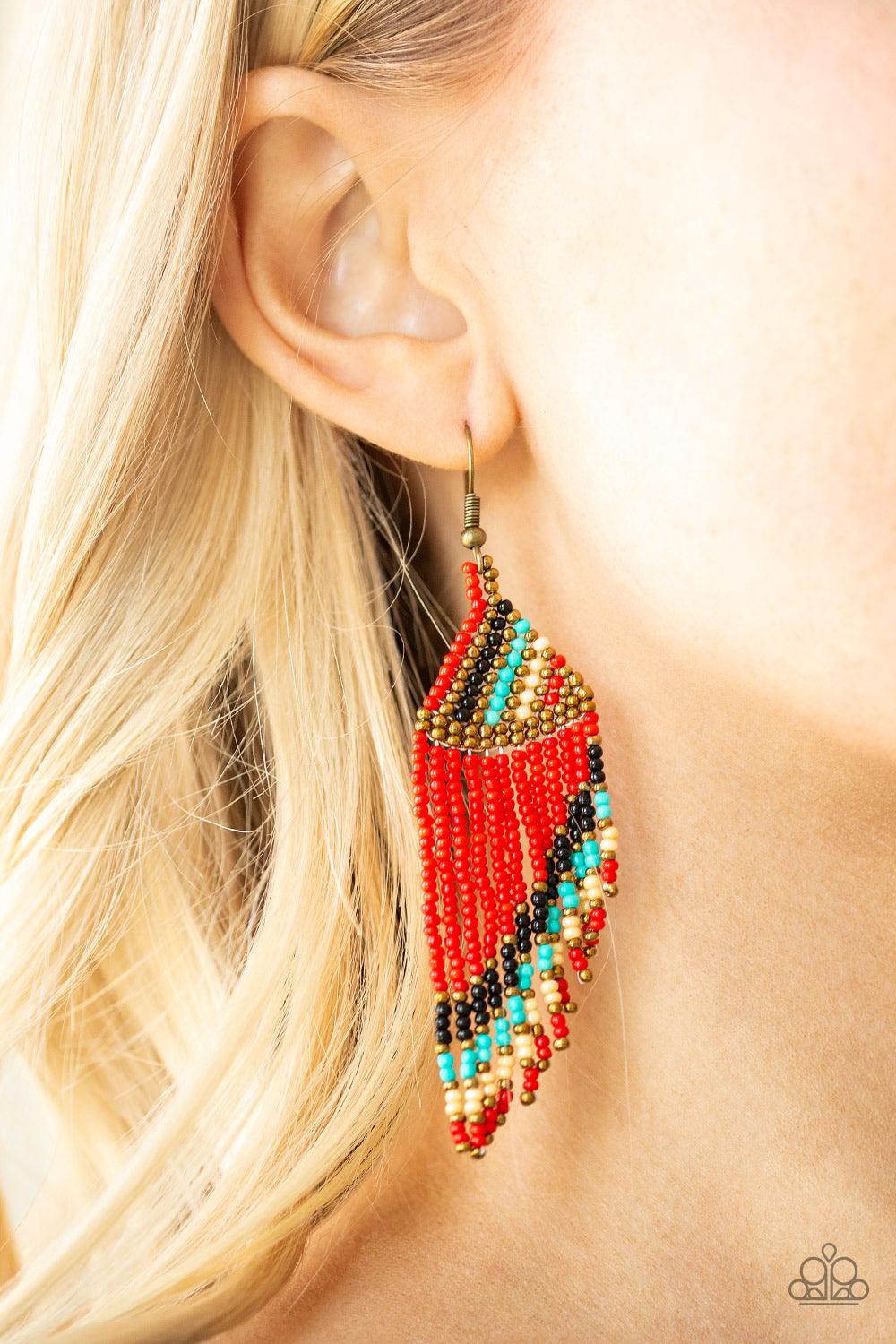 Paparazzi Accessories Bodaciously Bohemian - Red Featuring black, red, brass, blue, and golden-white beads, dainty beaded tassels slant from the bottom of a beaded triangular frame for a tribal inspired look. Earring attaches to a standard fishhook fittin