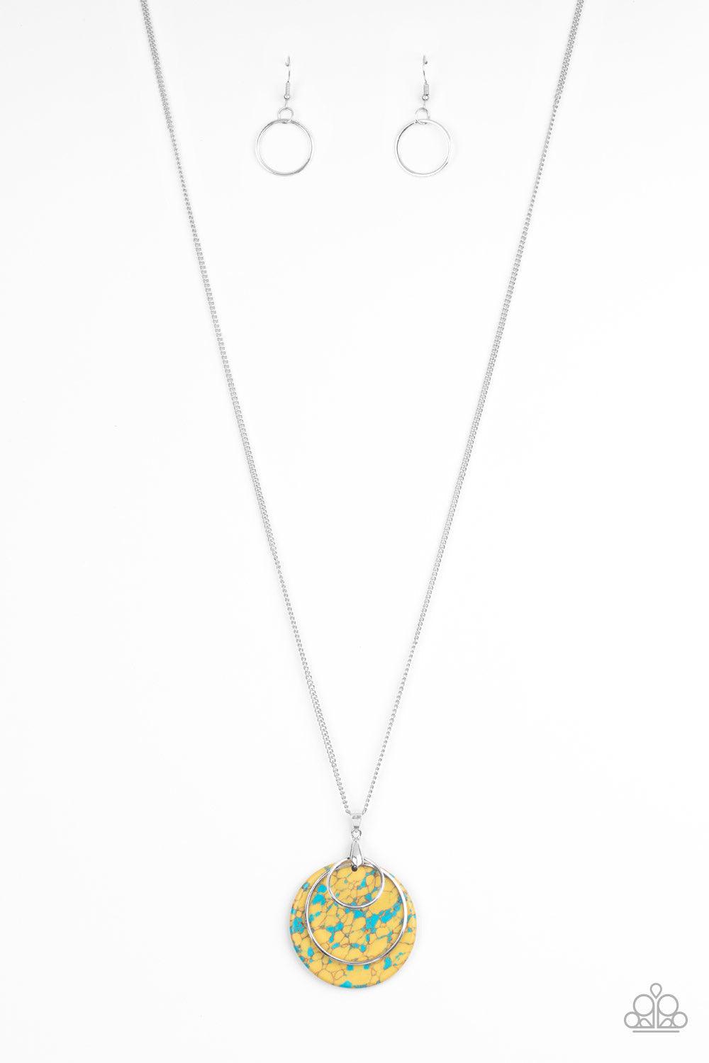 Paparazzi Accessories Sahara Equinox - Yellow Featuring a faux stone finish, an earthy yellow frame swings behind two shimmery silver rings at the bottom of a lengthened silver chain, creating a colorfully stacked pendant. Features an adjustable clasp clo