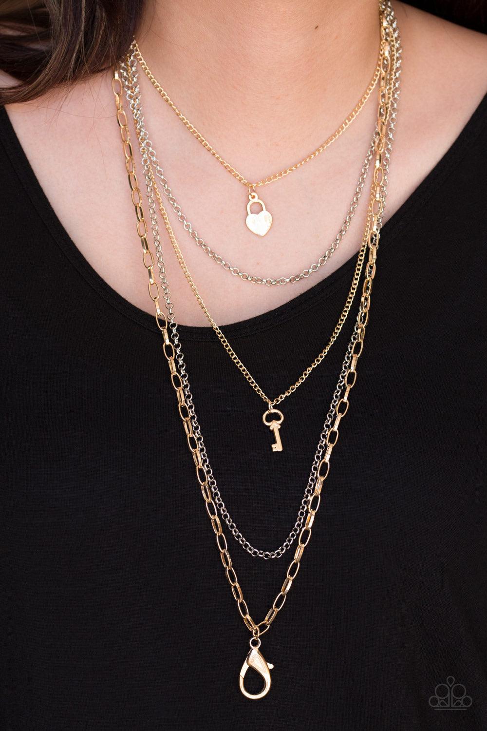 Paparazzi Accessories Right On Key - Multi *Lanyard Layers of gold and silver chain fall together to create the illusion of five separate necklaces. Each gold chain is adorned with a small gold charm, including a heart and a key. A lobster clasp hangs fro