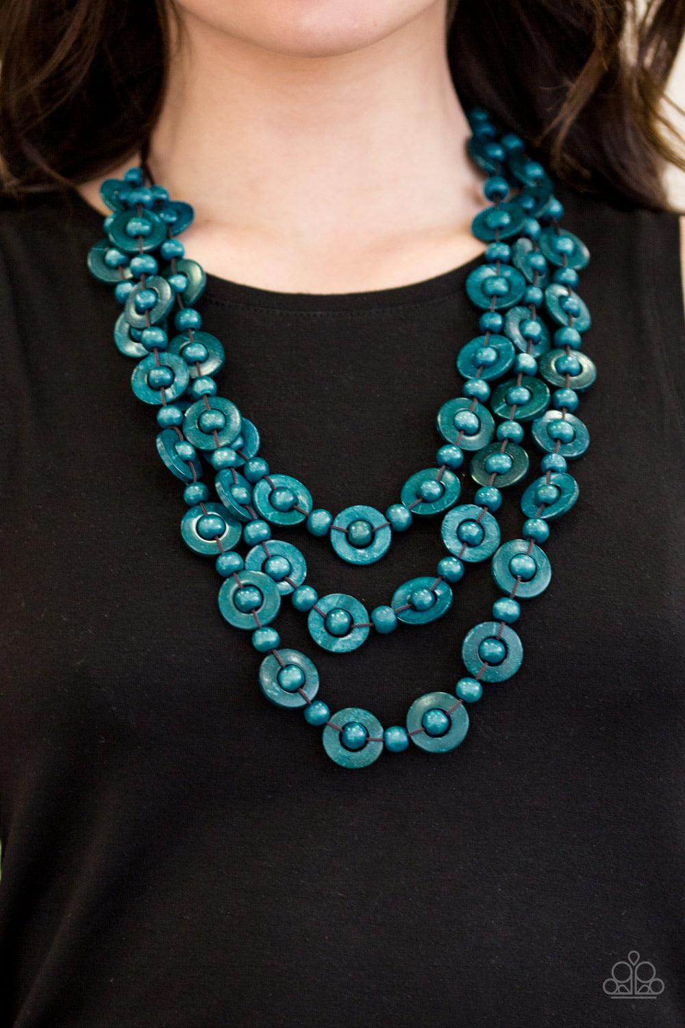 Paparazzi Accessories Bermuda Belle - Blue Brushed in a refreshing blue finish, wooden rings and beads are knotted in place along three strands, creating summery layers down the chest. Features a button loop closure. Jewelry