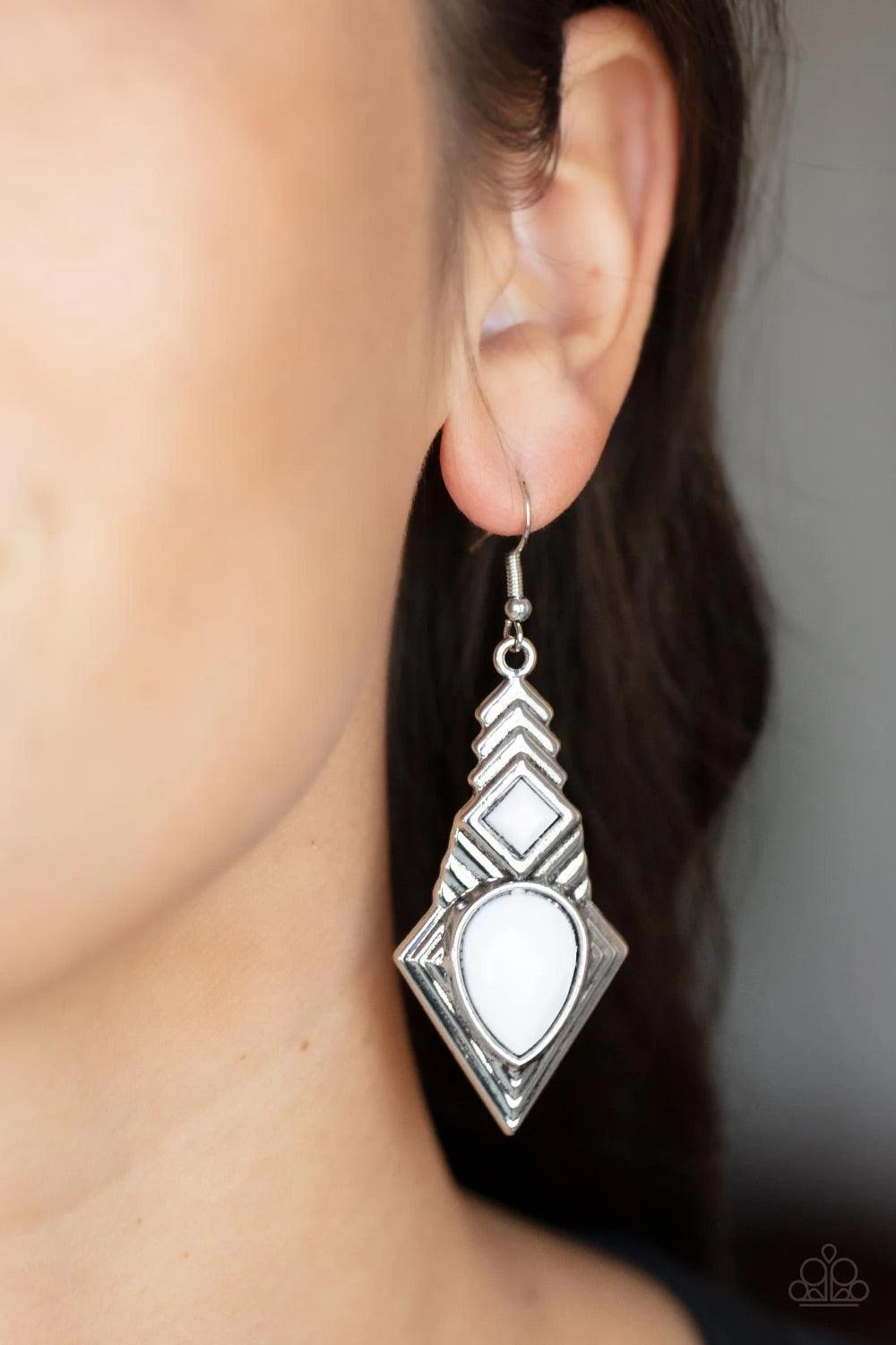 Paparazzi Accessories Stylishly Sonoran - White Faceted white square and teardrop beads are pressed into a silver geometric frame rippling with stacked linear patterns. Earring attaches to a standard fishhook fitting. Sold as one pair of earrings. Jewelry