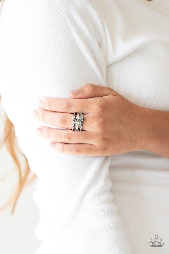 Paparazzi Accessories Head in the Stars - Silver A trio of glittery hematite rhinestones are sprinkled along smooth and twisted silver bands, creating edgy layers across the finger. Features a stretchy band for a flexible fit. Sold as one individual ring.