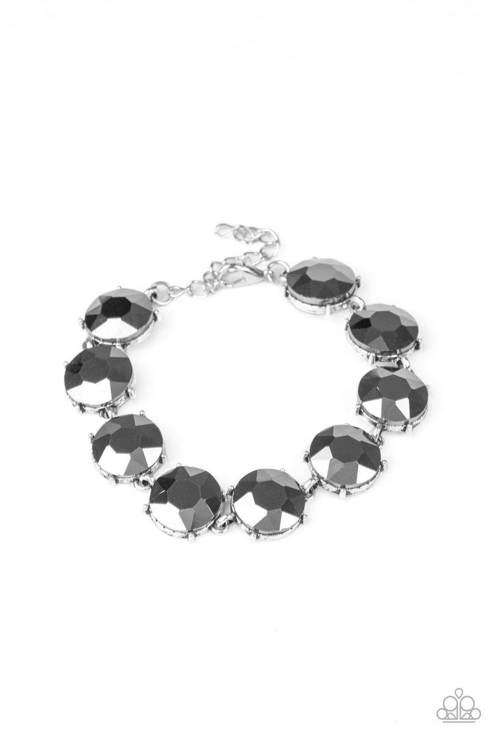 Paparazzi Accessories Fabulously Flashy - Silver Nestled inside classic silver fittings, a collection of oversized hematite rhinestones delicately link around the wrist for a flashy finish. Features an adjustable clasp closure. Sold as one individual brac