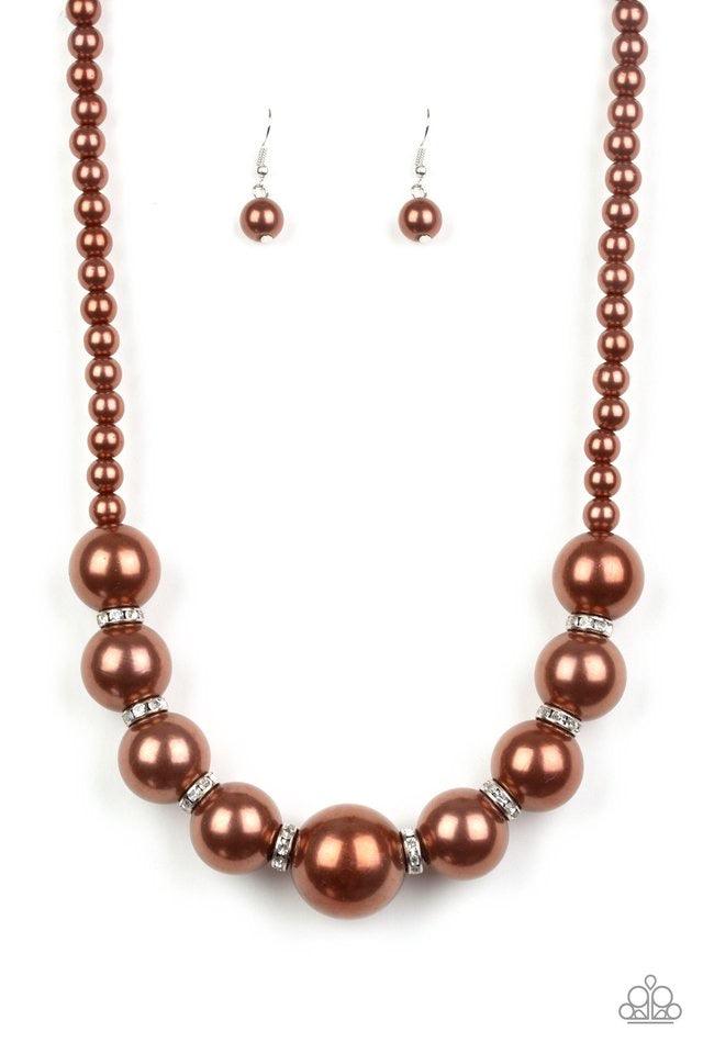 Paparazzi Accessories SoHo Socialite - Brown Threaded along an invisible wire, classic brown pearls give way to an alternating collection of oversized brown pearls and white rhinestone encrusted rings below the collar for a timeless sparkle. Features an a