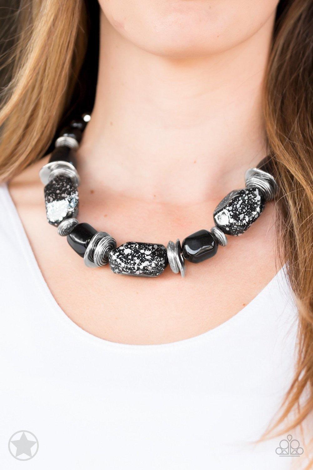 Paparazzi Accessories In Good Glazes - Black Chunky black beads with speckles of silver and a gorgeous glazed finish are threaded together with thick silver rings and smooth black beads. Features an adjustable clasp closure. Jewelry