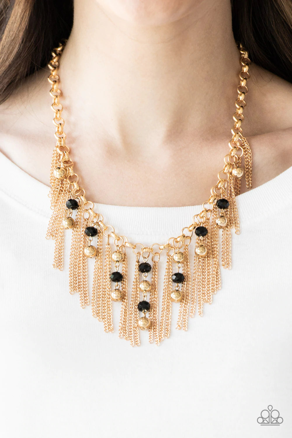 Paparazzi Accessories Ever Rebellious - Gold Glistening gold chains and strands of black crystal-like beads and glistening gold beads stream from the bottom of a bold gold chain, creating a sassy fringe below the collar. Features an adjustable clasp closu