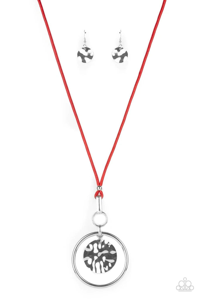 Paparazzi Accessories CORD-inated Effort - Red An oversized hammered disc swings from the top of a bold silver hoop that attaches to mismatched silver fittings at the bottom of a lengthened red cord, creating a dramatic pendant. Features an adjustable cla
