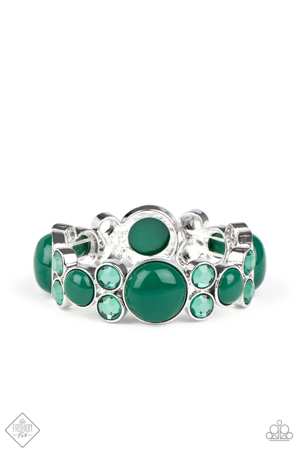 Paparazzi Accessories Celestial Escape - Green Infused with pairs of Ultramarine Green rhinestones, mismatched Ultramarine Green beaded silver frames are delicately threaded along stretchy bands around the wrist for a whimsical pop of color. Sold as one i