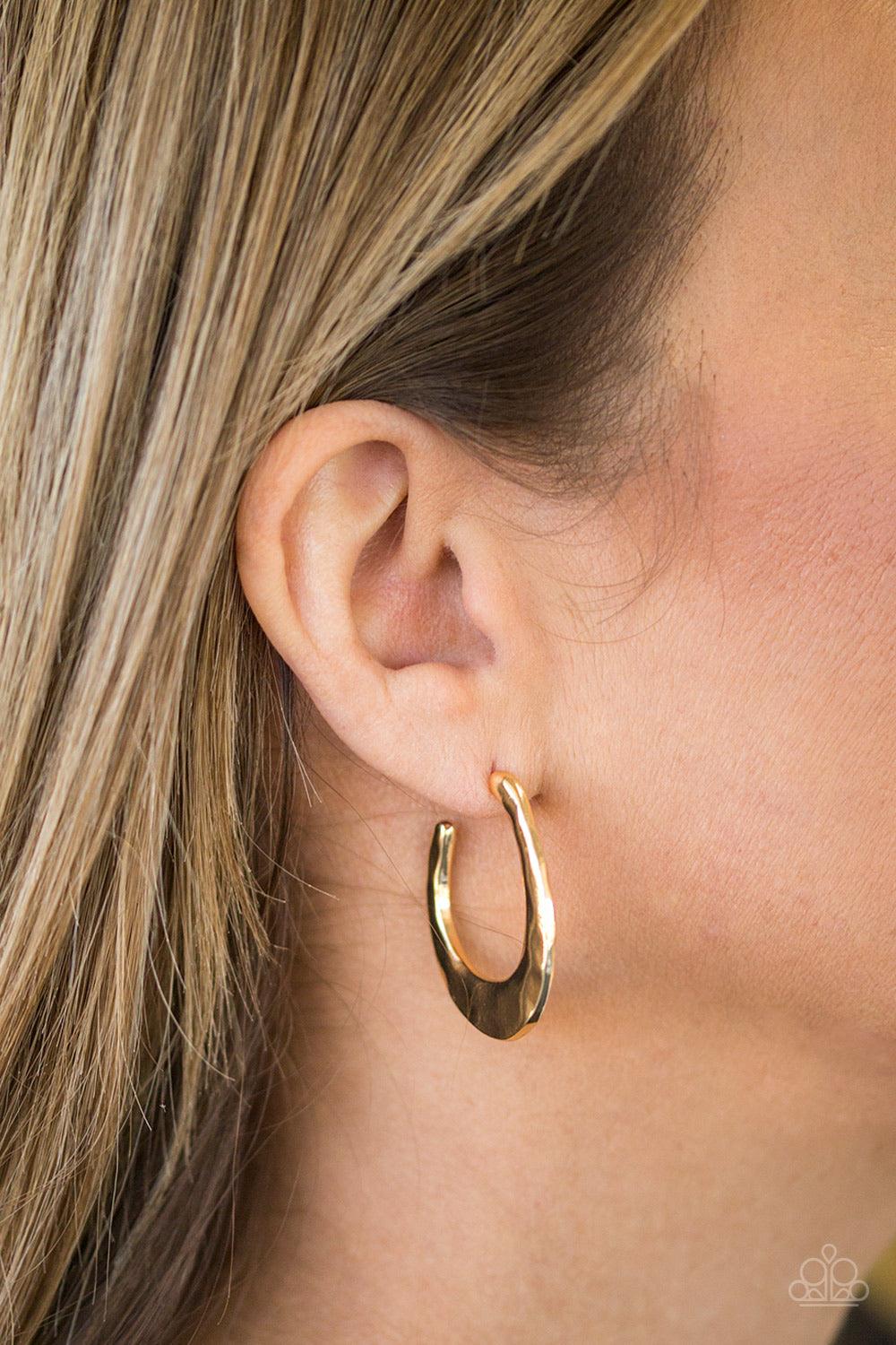 Paparazzi Accessories HOOP Me Up! - Gold Delicately hammered in shimmery textures, an asymmetrical hoop curls around the ear for an edgy look. Earring attaches to a standard post fitting. Hoop measures 1" in diameter. Jewelry