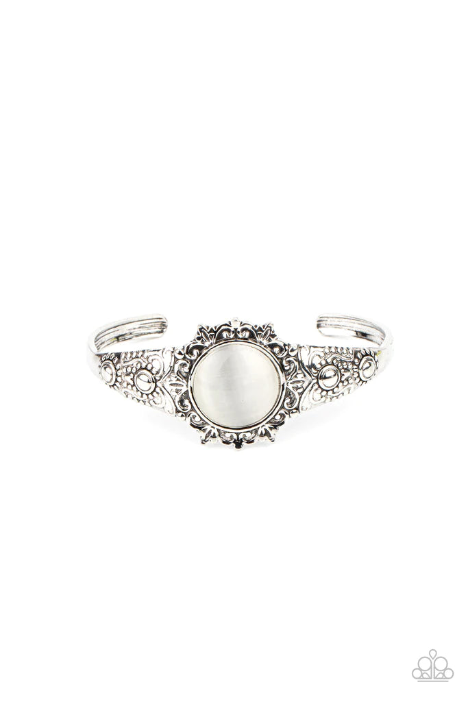 Paparazzi Accessories Extravagantly Enchanting - White A mystical white cat's eye stone is pressed into the floral center of a dainty silver cuff that is abloom with flowery details, creating an enchanting pop of color around the wrist. Sold as one indivi