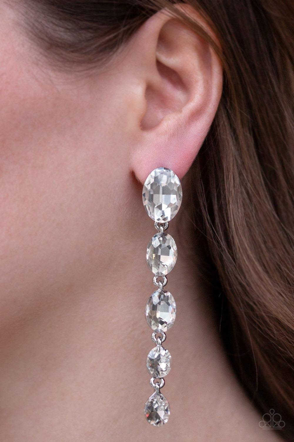 Paparazzi Accessories Red Carpet Radiance - White Gradually decreasing in size, glittery white gems trickle from the ear in a glamorous fashion. Earring attaches to a standard post fitting. Jewelry