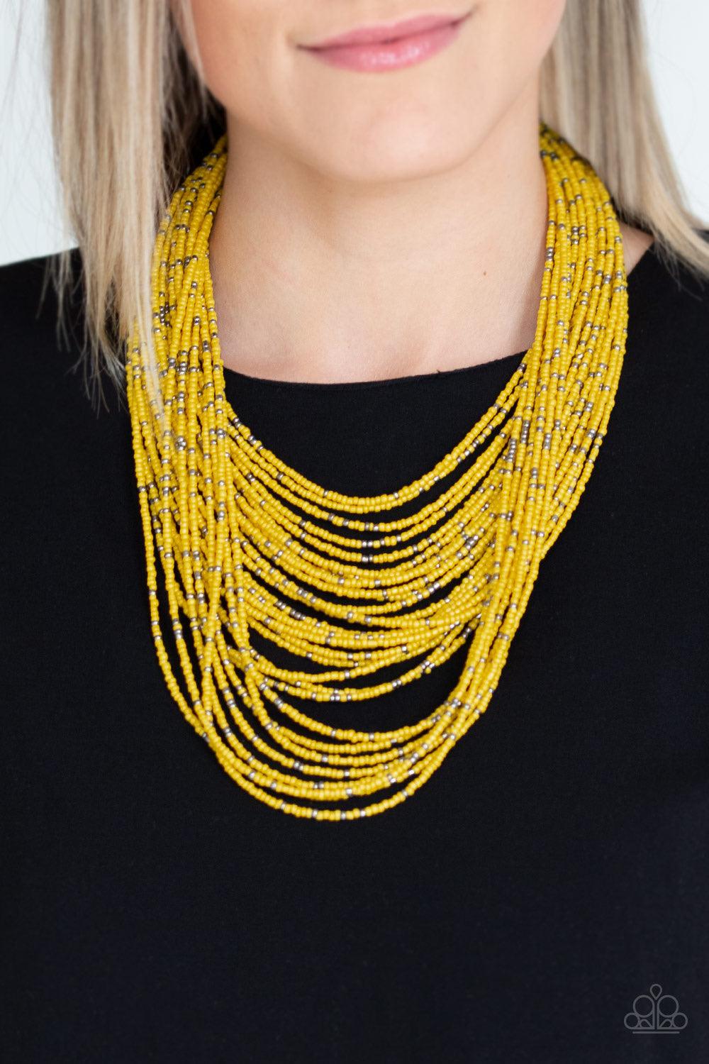 Paparazzi Accessories Rio Rainforest - Yellow Suspended between two gunmetal fittings, row after row of countless strands of yellow seed beads layer below the collar. Dainty gunmetal seed beads are sprinkled across the strands for a seasonal finish. Featu
