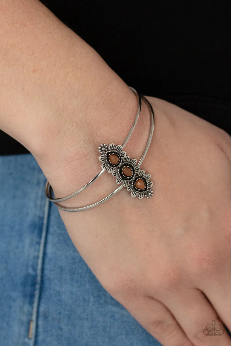 Paparazzi Accessories Fairytale Flowerbeds - Orange Infused with glassy orange stone centers, silver flowery frames stack across the center of an airy silver cuff for an enchanted fashion. Sold as one individual bracelet. Bracelets