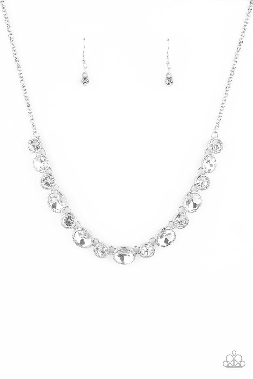 Paparazzi Accessories Girls Gotta Glow - White Encased in sleek silver frames, oval and round white rhinestones alternate below the collar for a timeless look. Features an adjustable clasp closure. Sold as one individual necklace. Includes one pair of mat