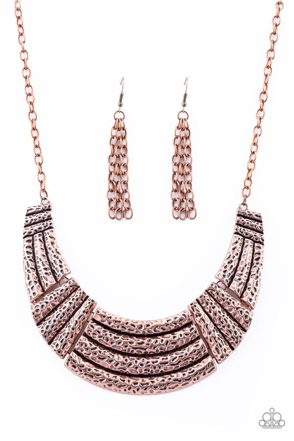 Paparazzi Accessories Ready to Pounce - Copper A collection of hammered copper plates connect into a dramatic half-moon pendant below the collar for a fierce look. Features an adjustable clasp closure. Sold as one individual necklace. Includes one pair of