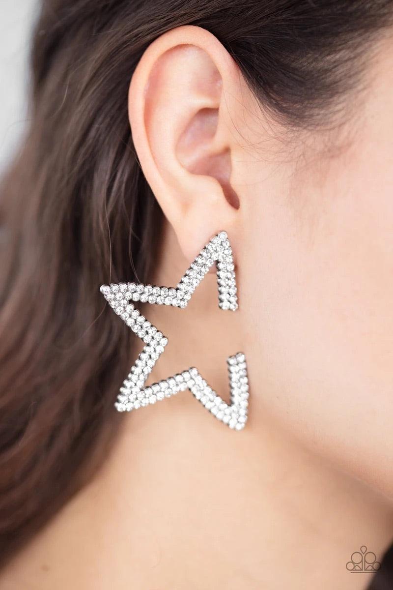 Paparazzi Accessories Star Player - White Encrusted in two rows of glittery white rhinestones, a silver star frame dots the ear for a stellar shimmer. To flatter the natural contour of the face, one side angle of the star frame is intentionally left open.