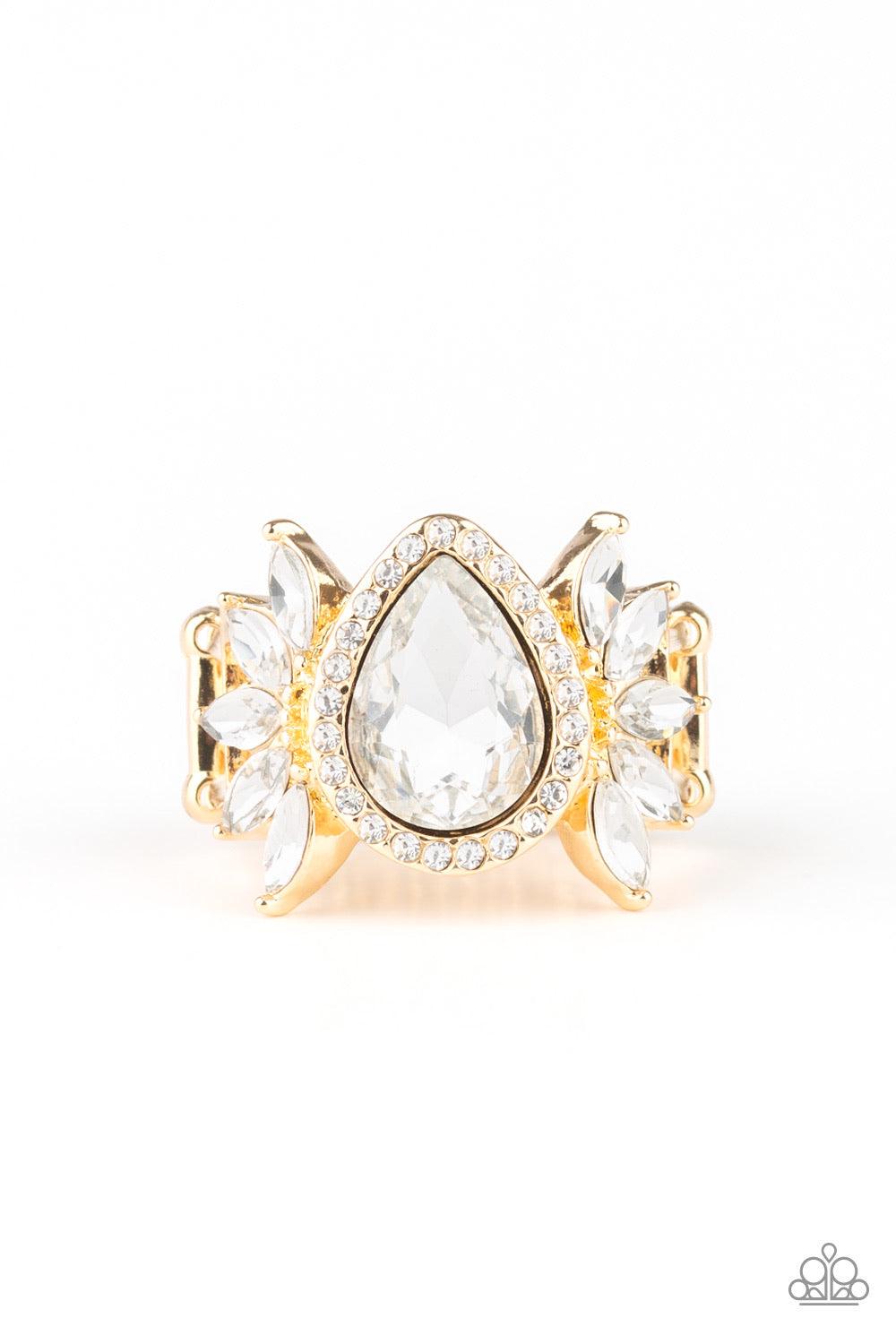 Paparazzi Accessories Really Regal - Gold An oversized white teardrop rhinestone is nestled between two gold frames radiating with fans of white marquise-style rhinestones. Features a stretchy band for a flexible fit. Jewelry