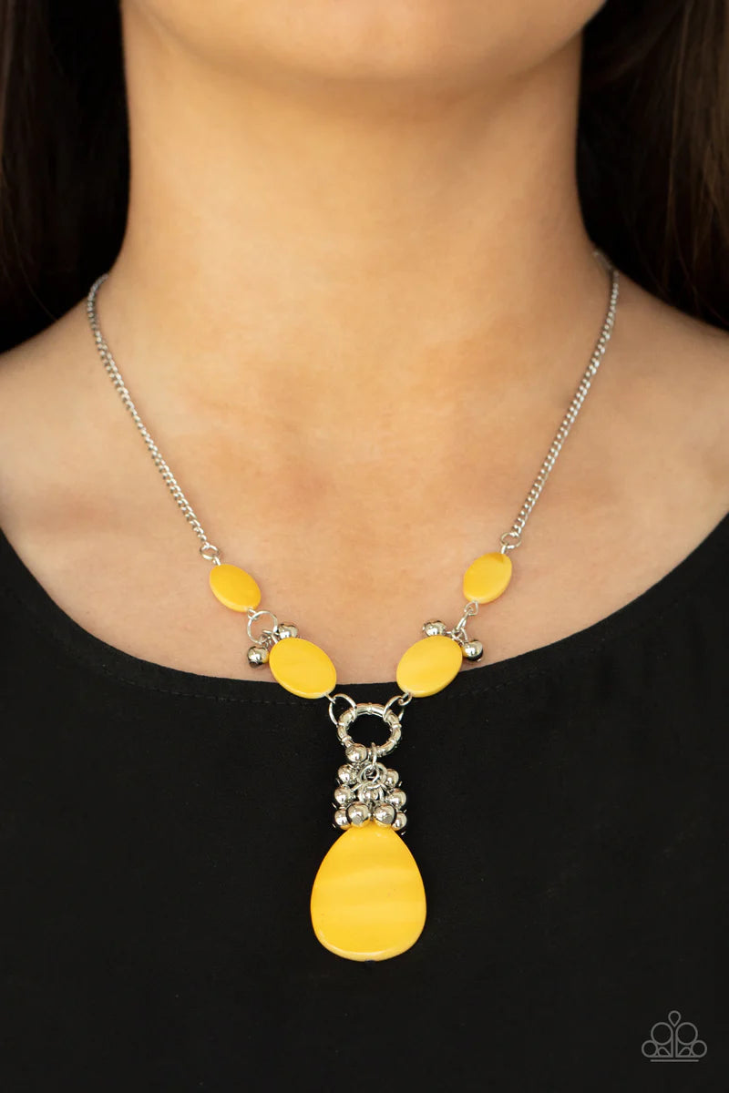 Paparazzi Accessories Summer Idol - Yellow Oval Illuminating shell-like beads link with pairs of dainty silver beads below the collar. A cluster of shiny silver beads and an oversized Illuminating shell-like teardrop swings from the bottom, creating a vib