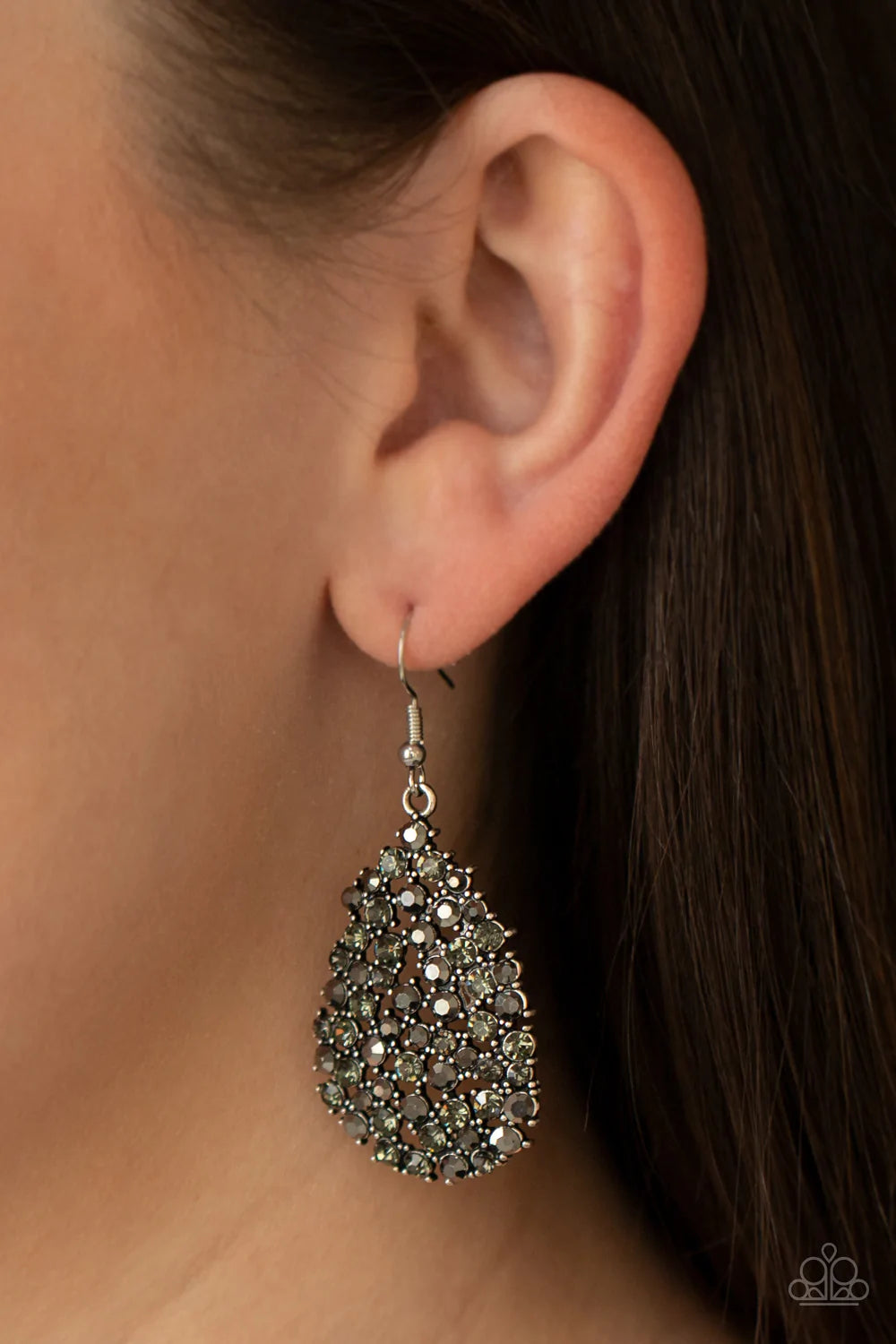 Paparazzi Accessories Daydreamy Dazzle - Silver Featuring studded silver fittings, a smoldering collection of smoky and hematite rhinestones coalesce into a dazzling teardrop frame. Earring attaches to a standard fishhook fitting. Sold as one pair of earr